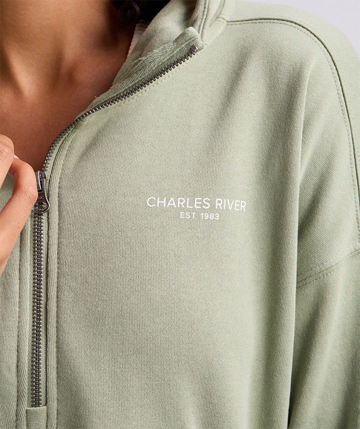 Close-up of zipper and left chest logo on Sage scallop hem hoodie